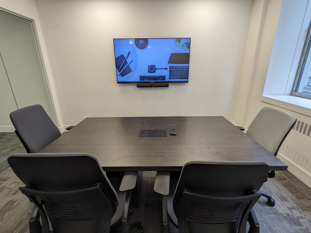 Meeting space featuring the Barco ClickShare for wireless meeting collaboration capabilities.